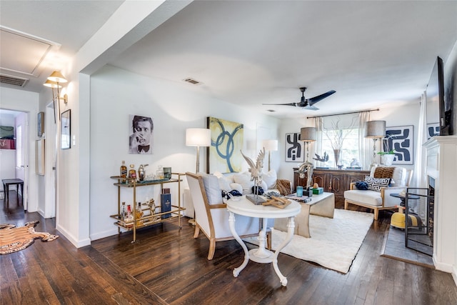 dining area featuring visible vents, baseboards, a ceiling fan, hardwood / wood-style floors, and attic access