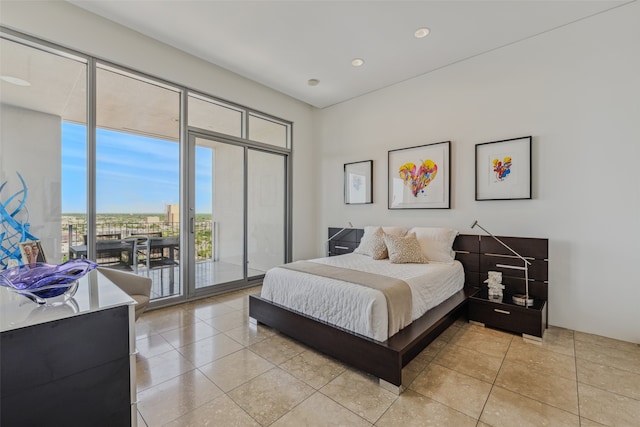 bedroom with access to outside and light tile patterned flooring