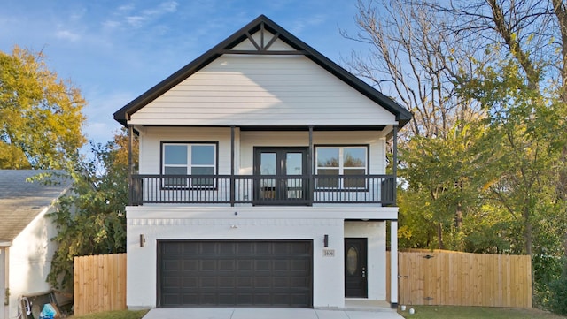 view of front of property featuring a garage and a balcony