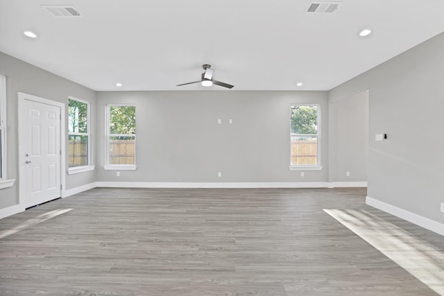 unfurnished room featuring light hardwood / wood-style flooring and ceiling fan