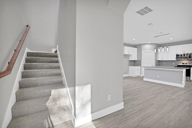 stairs with wood-type flooring