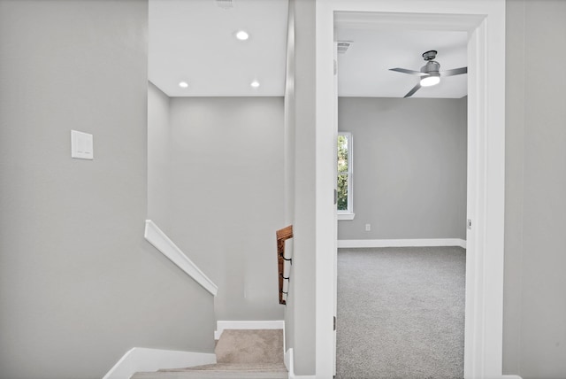 stairs with carpet and ceiling fan