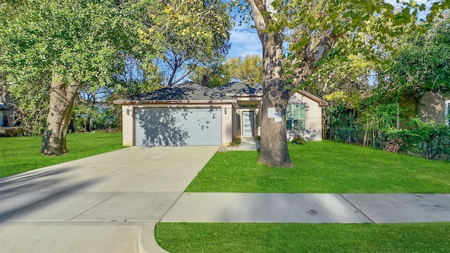 ranch-style home featuring a garage and a front yard