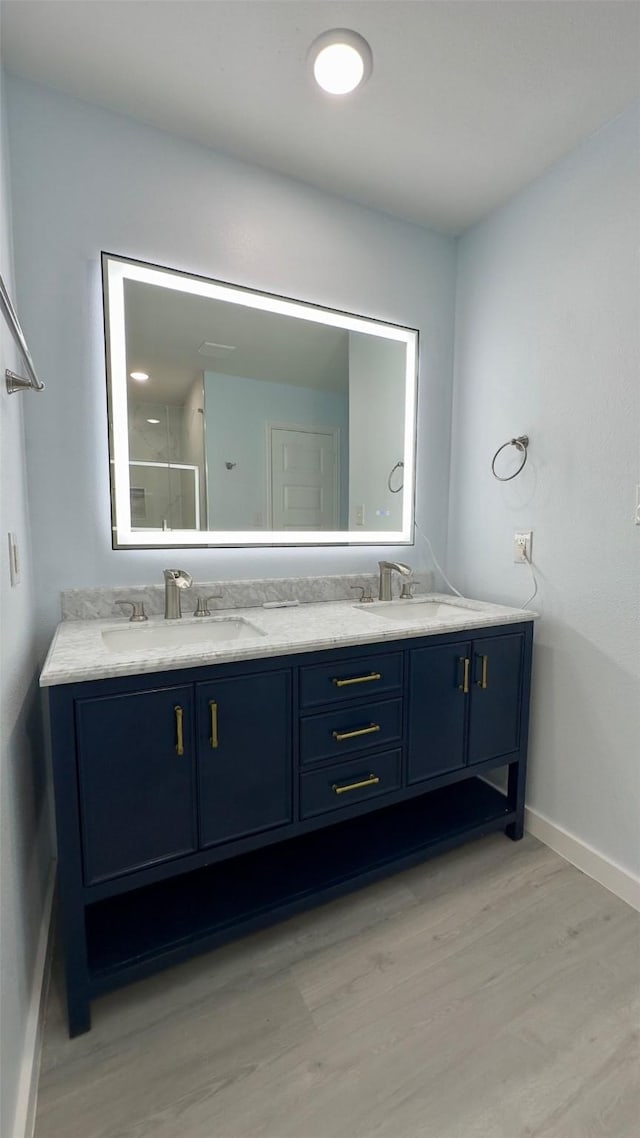 bathroom featuring wood-type flooring and vanity