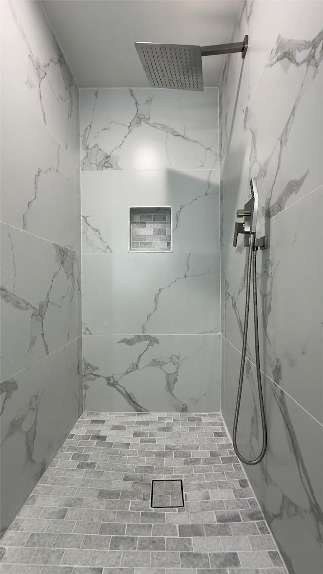 bathroom with tiled shower