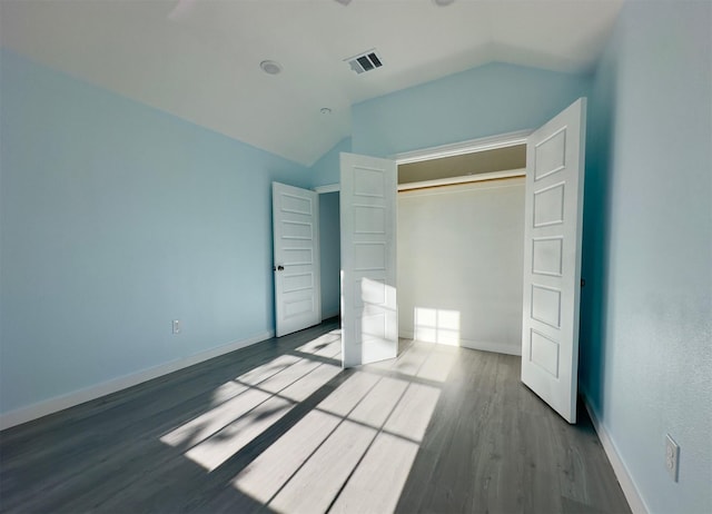 unfurnished bedroom featuring a closet, ceiling fan, hardwood / wood-style floors, and lofted ceiling