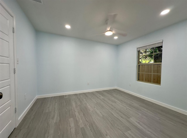 spare room featuring wood-type flooring and ceiling fan