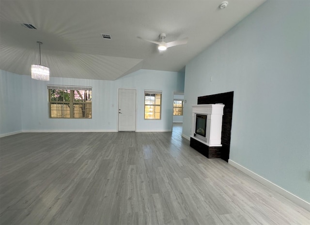 unfurnished living room featuring ceiling fan, a multi sided fireplace, light hardwood / wood-style floors, and lofted ceiling