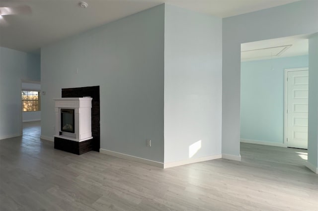 unfurnished living room with light hardwood / wood-style floors and a multi sided fireplace