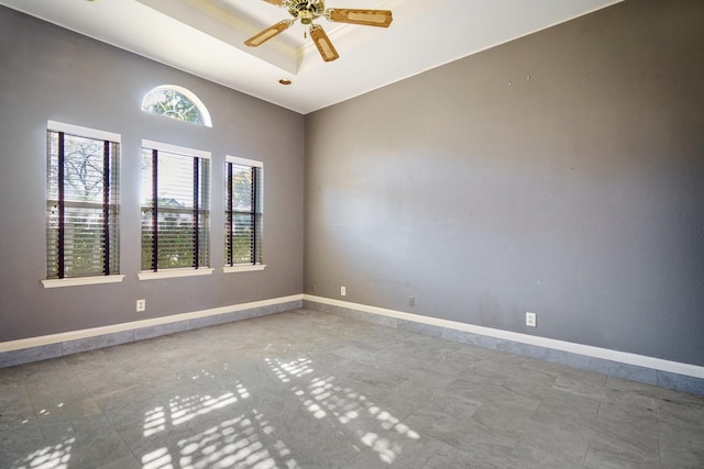 unfurnished room with a tray ceiling and ceiling fan