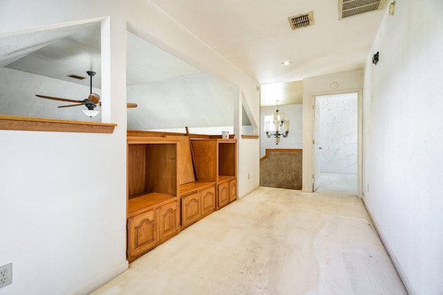 bathroom with vaulted ceiling and ceiling fan with notable chandelier