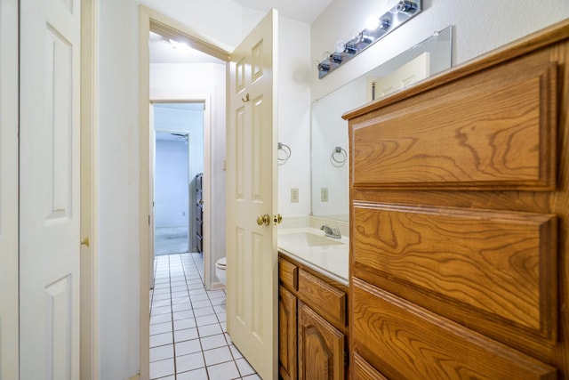 bathroom featuring tile patterned floors, vanity, and toilet