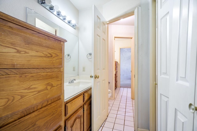 bathroom featuring tile patterned floors, vanity, and toilet