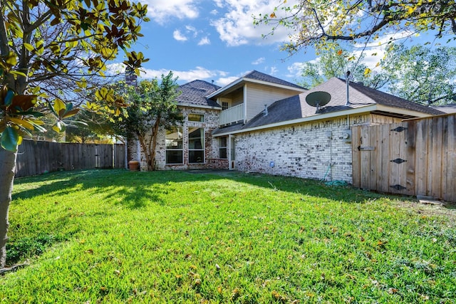 rear view of property with a lawn