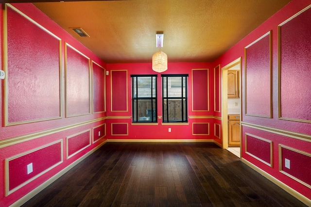 empty room featuring dark hardwood / wood-style flooring