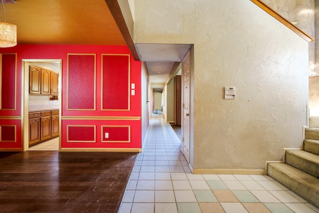 hall featuring light tile patterned floors