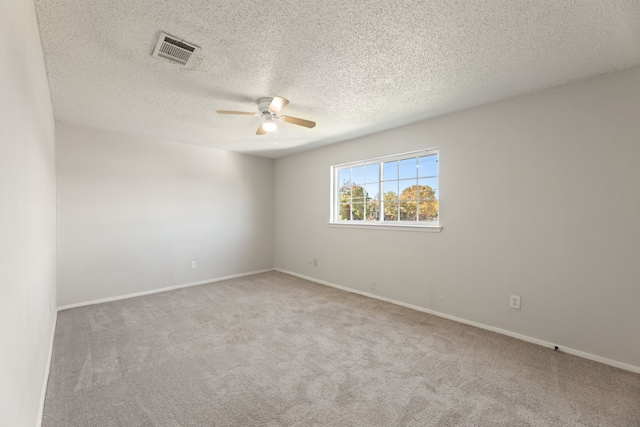 carpeted empty room with a textured ceiling and ceiling fan