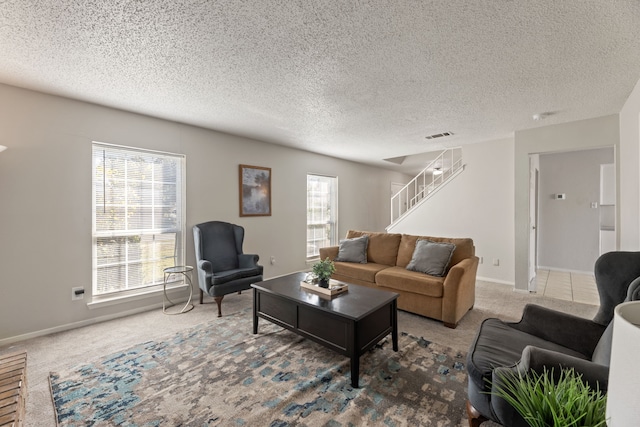 carpeted living room with a textured ceiling