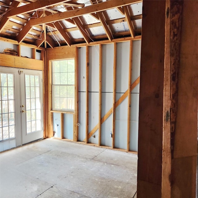 miscellaneous room featuring french doors and vaulted ceiling