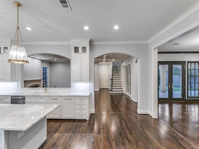 kitchen featuring french doors, white cabinetry, dark wood-type flooring, and sink