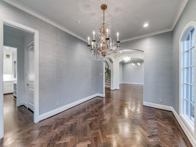 unfurnished dining area featuring dark parquet flooring, crown molding, and a notable chandelier