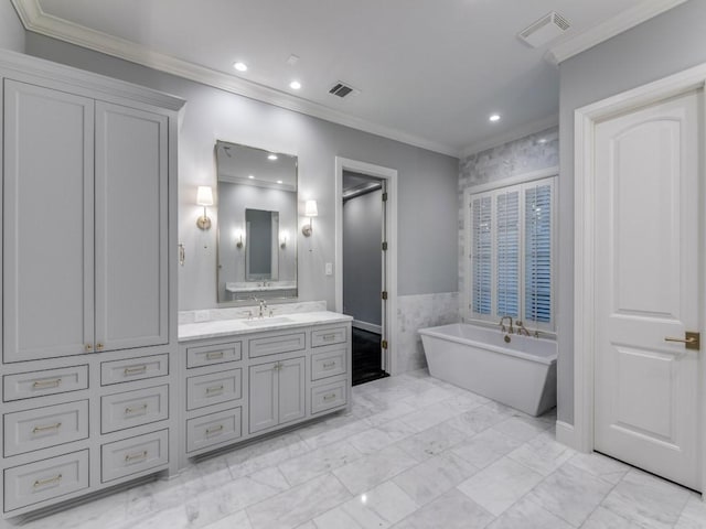 bathroom featuring a tub, vanity, tile walls, and ornamental molding