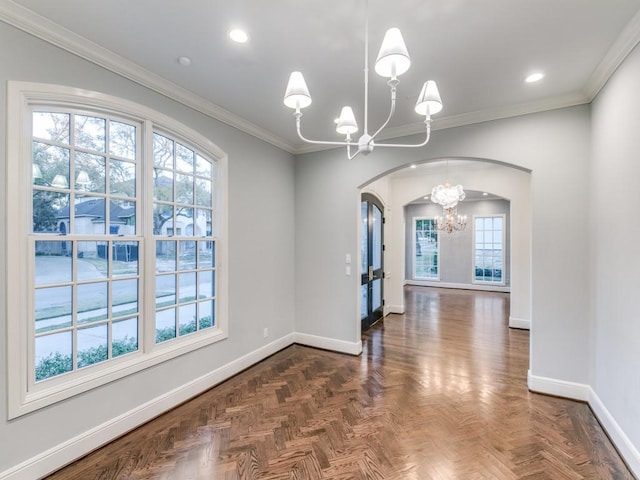 unfurnished dining area featuring a chandelier, dark parquet flooring, french doors, and crown molding