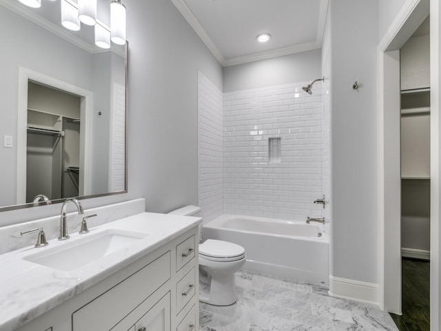 full bathroom with vanity, toilet, ornamental molding, and tiled shower / bath combo