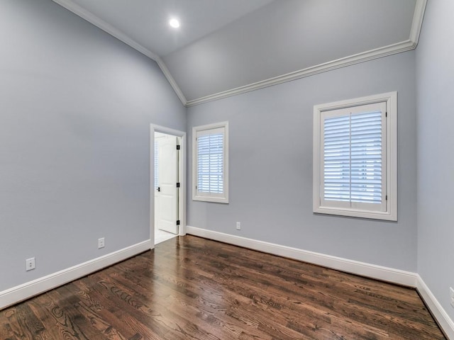 unfurnished room featuring dark hardwood / wood-style flooring, vaulted ceiling, and ornamental molding