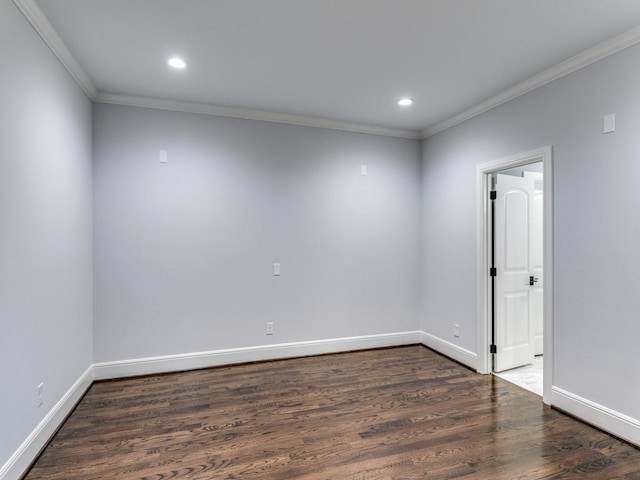 empty room with dark hardwood / wood-style flooring and ornamental molding