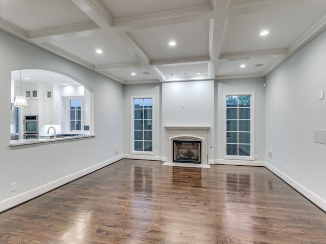 unfurnished living room with beamed ceiling, wood-type flooring, and coffered ceiling