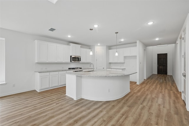 kitchen with white cabinetry, appliances with stainless steel finishes, visible vents, and light wood-style floors