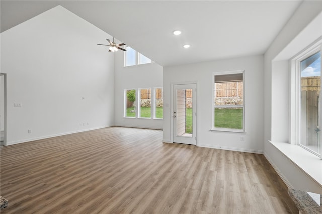 unfurnished living room featuring recessed lighting, baseboards, ceiling fan, and wood finished floors