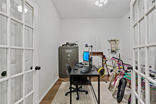 office space featuring french doors and dark hardwood / wood-style flooring