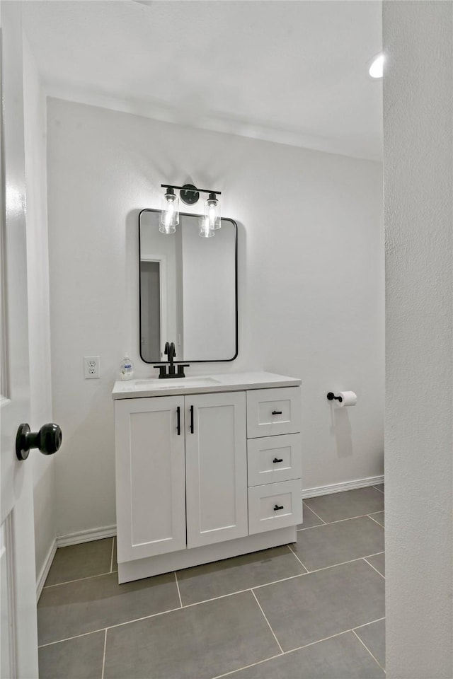 bathroom with tile patterned flooring and vanity