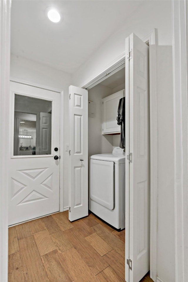 laundry room featuring cabinets and light hardwood / wood-style floors