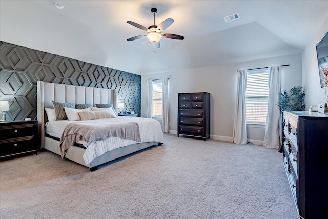 bedroom featuring light carpet, vaulted ceiling, and ceiling fan