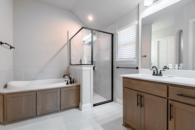 bathroom featuring tile patterned flooring, vanity, lofted ceiling, and shower with separate bathtub