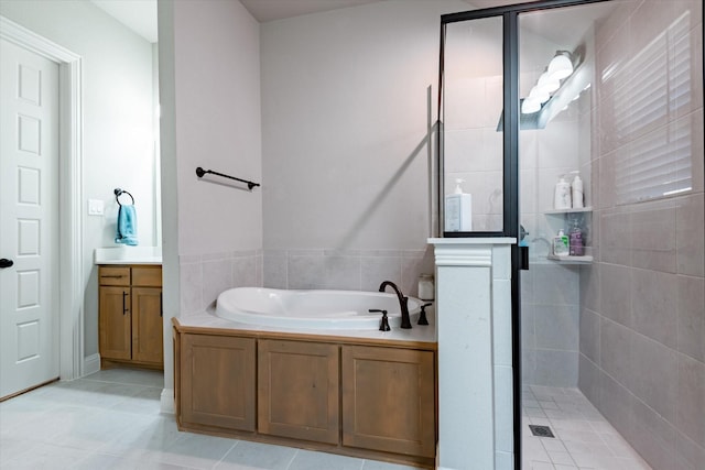 bathroom featuring tile patterned floors, vanity, and separate shower and tub