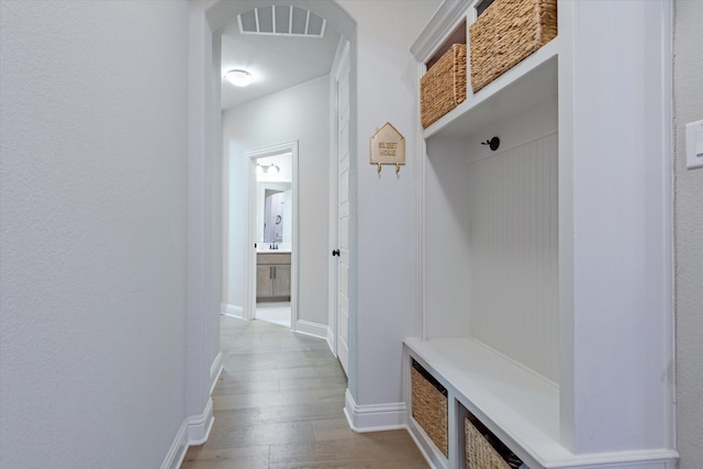 mudroom with light hardwood / wood-style floors