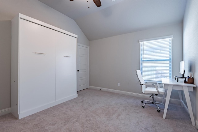 unfurnished office featuring light colored carpet, vaulted ceiling, and ceiling fan