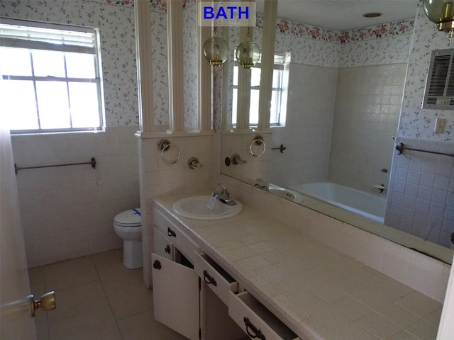 full bathroom featuring tile patterned floors, vanity, a healthy amount of sunlight, and toilet