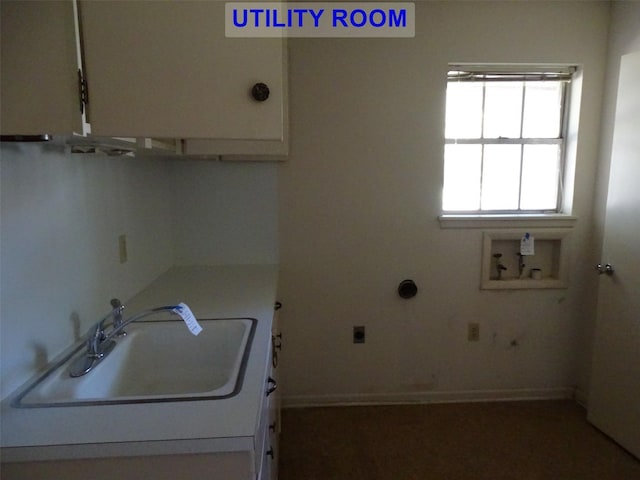 clothes washing area with electric dryer hookup, cabinets, sink, and washer hookup