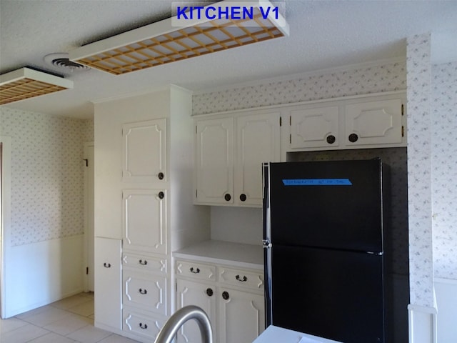 laundry area featuring light tile patterned flooring and a textured ceiling