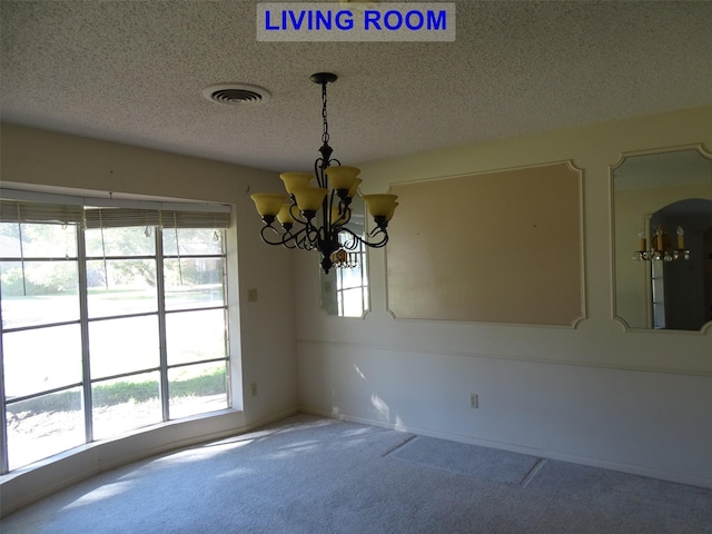 interior space with carpet, a textured ceiling, and a notable chandelier