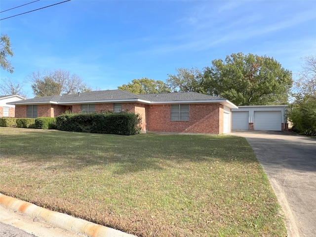 single story home featuring a front yard, an outbuilding, and a garage