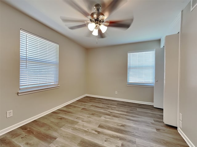 unfurnished room with ceiling fan and light wood-type flooring