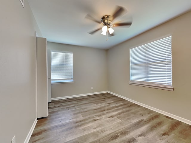 unfurnished room featuring ceiling fan and light wood-type flooring