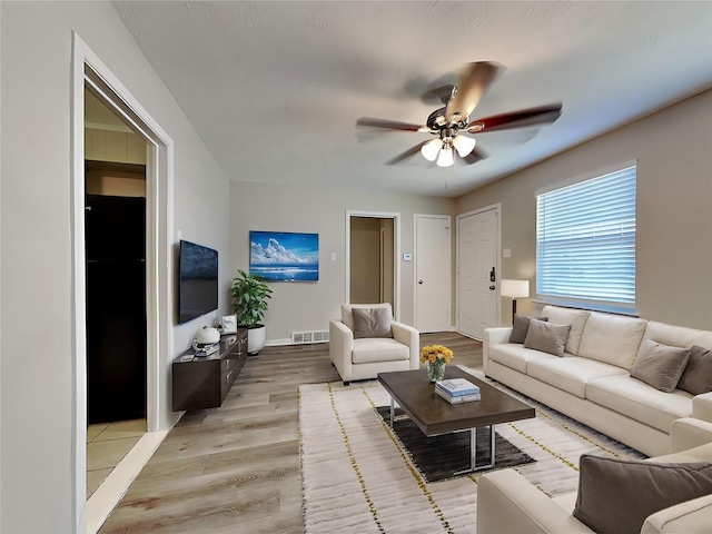 living room with hardwood / wood-style floors and ceiling fan