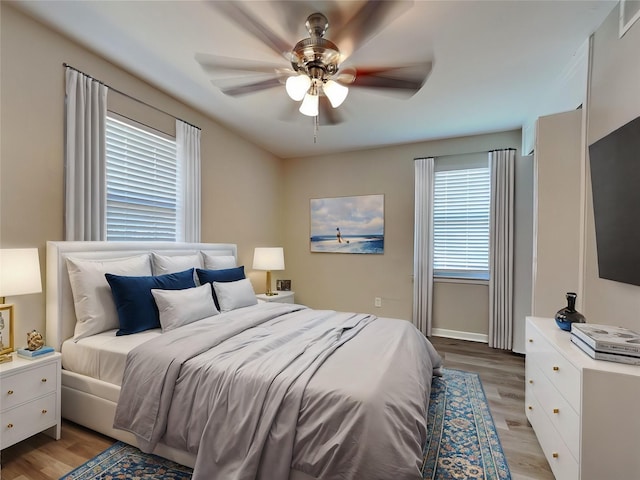 bedroom featuring light hardwood / wood-style floors and ceiling fan